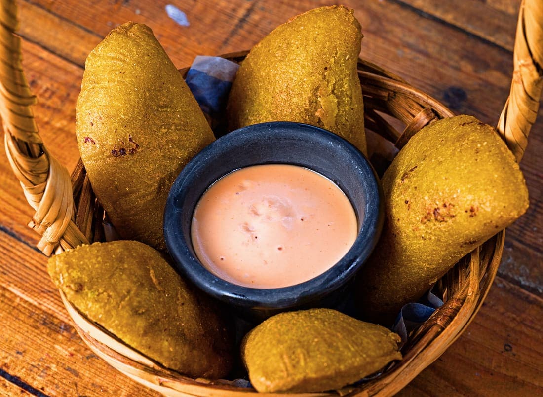 Empanadas colombianas recién fritas con ají para mojar